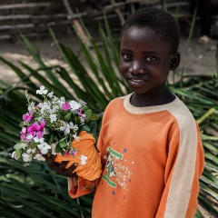 Little boy with a bouquet of flowers